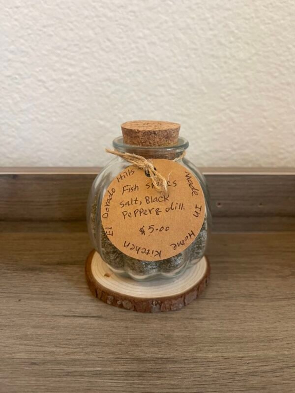 A JAR OF FISH SPICE SALT, BLACK PEPPER, AND DILL